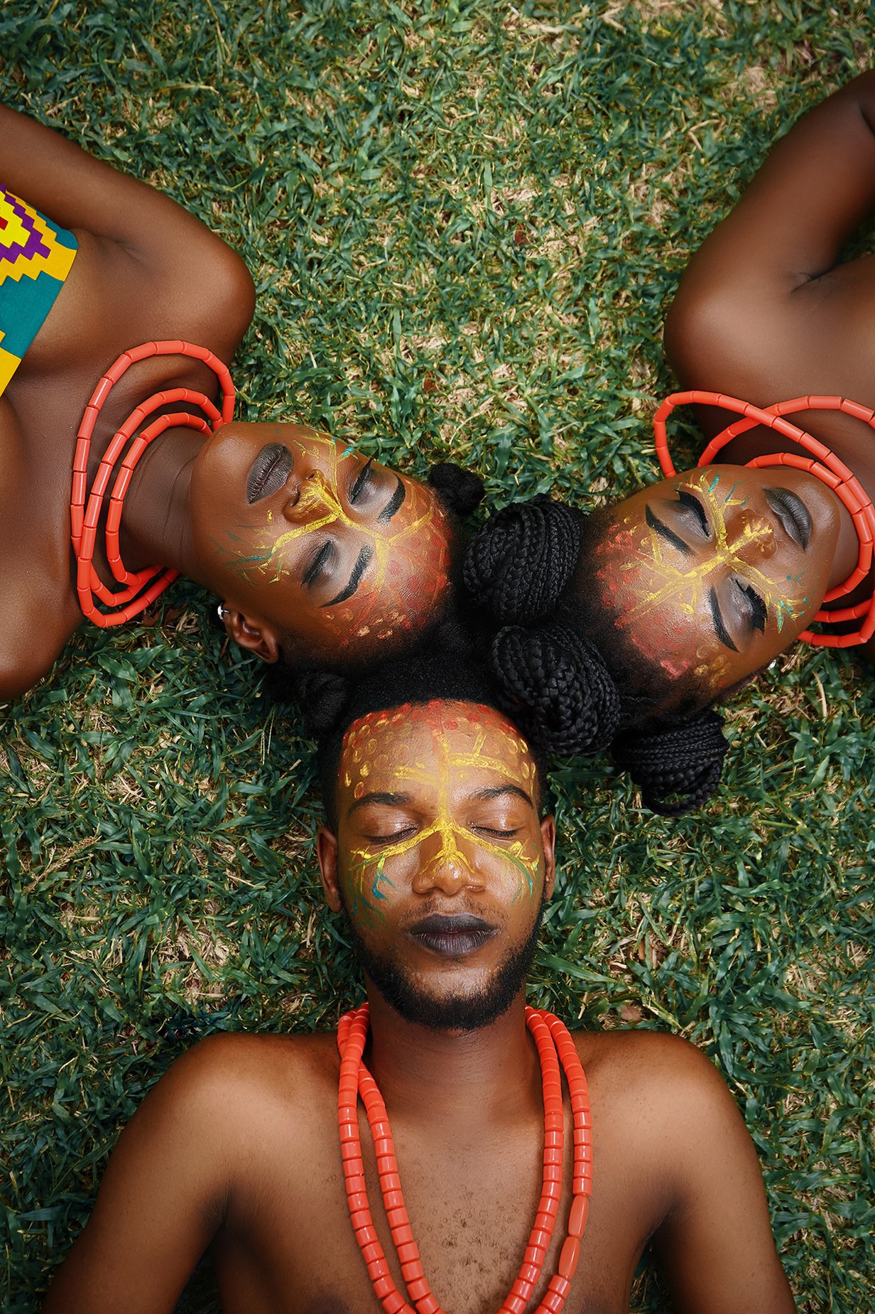 High-Angle Shot of People Lying on a Grassy Field